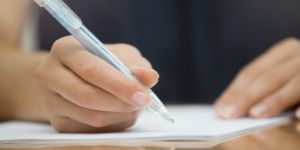 Woman writing with pen